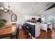 Modern kitchen featuring white cabinets, stainless steel appliances, a center island, and a dining area at 8103 Tar Hollow Dr, Gibsonton, FL 33534