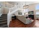 Spacious living area with hardwood floors, fireplace, and modern lighting showcases an inviting atmosphere for gatherings at 8103 Tar Hollow Dr, Gibsonton, FL 33534