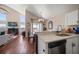 Bright open-concept living area features hardwood floors, vaulted ceilings, and seamless transition to the kitchen and dining area at 8103 Tar Hollow Dr, Gibsonton, FL 33534