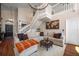 Spacious living room featuring high ceilings, white staircase, wood flooring and cozy furniture at 8103 Tar Hollow Dr, Gibsonton, FL 33534