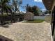 Large brick patio in the backyard with a storage shed, perfect for outdoor activities at 833 Lantana Ave, Clearwater Beach, FL 33767