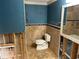 Bathroom with travertine tiled floor, unfinished drywall and toilet at 833 Lantana Ave, Clearwater Beach, FL 33767