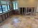 View of a dining area featuring tile flooring, windows providing natural light, and construction in progress at 833 Lantana Ave, Clearwater Beach, FL 33767