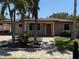 Charming home with paver walkway, mature palm trees, and inviting curb appeal at 833 Lantana Ave, Clearwater Beach, FL 33767