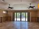 Spacious living room featuring natural stone flooring and bright, open space with glass doors to outdoors at 833 Lantana Ave, Clearwater Beach, FL 33767