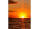 Experience golden sunsets over the ocean horizon with orange clouds and reflections on the waves at 833 Lantana Ave, Clearwater Beach, FL 33767