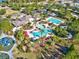 Aerial view of community amenities, including pools, playground, and clubhouse surrounded by lush landscaping at 8463 Dunham Station Dr, Tampa, FL 33647
