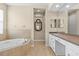 Luxurious bathroom with soaking tub, granite countertops and double sinks at 8463 Dunham Station Dr, Tampa, FL 33647