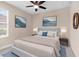 Well-lit bedroom featuring soft carpet, soothing wall art, and stylish bedside tables at 8463 Dunham Station Dr, Tampa, FL 33647