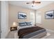A cozy bedroom with neutral tones, a tufted headboard, and soothing artwork on the walls at 8463 Dunham Station Dr, Tampa, FL 33647