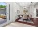 Elegant dining room with tray ceiling, chandelier, and access to the front door at 8463 Dunham Station Dr, Tampa, FL 33647