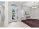 Bright foyer featuring tile and wood flooring, chandelier lighting and view to front yard at 8463 Dunham Station Dr, Tampa, FL 33647