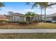 Charming single-story home featuring tidy landscaping and palm trees in a well-maintained front yard at 8463 Dunham Station Dr, Tampa, FL 33647