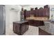 Spacious kitchen with granite countertops, tile flooring, stainless steel appliances, and dark wood cabinets at 8463 Dunham Station Dr, Tampa, FL 33647