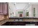 Open kitchen featuring granite countertops, stainless steel appliances, and a view into the living room at 8463 Dunham Station Dr, Tampa, FL 33647