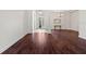 Large living area with wood floors, opening to a dining area at 8463 Dunham Station Dr, Tampa, FL 33647