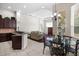 Open floor plan featuring kitchen island seating, a dining table, and living room with trey ceiling at 8463 Dunham Station Dr, Tampa, FL 33647