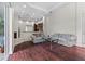 Spacious living room with hardwood floors and a view of the kitchen through an open floorplan at 8463 Dunham Station Dr, Tampa, FL 33647