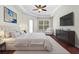 Spacious main bedroom with tray ceiling, TV, and luxurious furnishings at 8463 Dunham Station Dr, Tampa, FL 33647