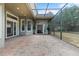 Spacious brick patio with screened enclosure offers a seamless transition to the outdoors at 8463 Dunham Station Dr, Tampa, FL 33647