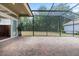 Large screened patio featuring brick flooring with easy access to the indoors and backyard at 8463 Dunham Station Dr, Tampa, FL 33647
