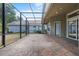 Expansive screened patio with brick flooring, providing ample space for outdoor enjoyment at 8463 Dunham Station Dr, Tampa, FL 33647