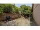 Charming backyard featuring a grill, quaint seating area, and a privacy fence perfect for outdoor gatherings at 9327 Pontiac Dr, Tampa, FL 33626