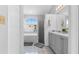 Bathroom with walk-in shower, soaking tub, and updated double sink vanity at 9327 Pontiac Dr, Tampa, FL 33626