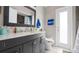 This bathroom has a gray vanity, a white marble countertop, and a door leading to the exterior at 9327 Pontiac Dr, Tampa, FL 33626