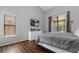 Bedroom with laminate floors, dresser, TV, and a sliding door to backyard at 9327 Pontiac Dr, Tampa, FL 33626