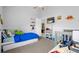 This bedroom has a ceiling fan, a bed, toys, closet and tv mounted on the wall at 9327 Pontiac Dr, Tampa, FL 33626