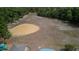 Aerial view of vacant field with a baseball diamond and partially visible playground, all surrounded by mature trees at 9327 Pontiac Dr, Tampa, FL 33626