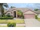 Charming single-story home featuring well-manicured landscaping and a two-car garage at 9327 Pontiac Dr, Tampa, FL 33626