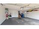 Spacious garage with white walls, storage shelves, and a gray concrete floor, providing ample parking at 9327 Pontiac Dr, Tampa, FL 33626