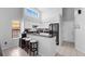 Modern kitchen features white cabinets, stainless steel appliances, black countertops, and ample counter space at 9327 Pontiac Dr, Tampa, FL 33626