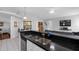 Kitchen with granite countertops, stainless sink, and view into the living space at 9327 Pontiac Dr, Tampa, FL 33626