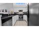 Well-lit kitchen with white cabinets, stainless appliances, bar stool seating, and a bright atrium window at 9327 Pontiac Dr, Tampa, FL 33626