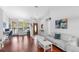 Open-concept living room featuring hardwood floors, white walls, and ample natural light from large windows at 9327 Pontiac Dr, Tampa, FL 33626