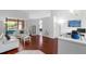 Bright living room with hardwood floors, white furniture, and large windows that bring in natural light at 9327 Pontiac Dr, Tampa, FL 33626