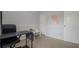 The office space has gray carpet, two doors, and includes a black desk and rolling office chair at 9327 Pontiac Dr, Tampa, FL 33626