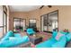 This screened in patio features tiled floor, a ceiling fan and comfortable blue couches at 9327 Pontiac Dr, Tampa, FL 33626