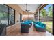 This screened in patio features tiled floor and outdoor furniture and a ceiling fan at 9327 Pontiac Dr, Tampa, FL 33626