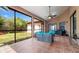 View of screened-in patio with fan, tile floors, and patio furniture with a view of the backyard at 9327 Pontiac Dr, Tampa, FL 33626