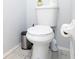 This features a white toilet with blue patterned tile floor, plus a trash can, brush and toilet paper holder at 9327 Pontiac Dr, Tampa, FL 33626