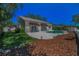 Well-maintained backyard with a pool, manicured lawn, mulch bed and patio creating a peaceful outdoor space at 962 Marco Ne Dr, St Petersburg, FL 33702