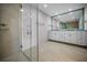 Bright bathroom with a modern glass shower, double sinks, and sleek vanity at 962 Marco Ne Dr, St Petersburg, FL 33702