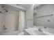 Well-lit bathroom featuring a shower-tub combination with white tile and a large mirror above the sink at 962 Marco Ne Dr, St Petersburg, FL 33702