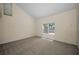 Light-filled bedroom with vaulted ceiling, neutral carpet, and bright window at 962 Marco Ne Dr, St Petersburg, FL 33702