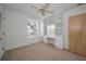 Cozy bedroom with built-in shelving unit, a window seat, carpeted floor, and a ceiling fan at 962 Marco Ne Dr, St Petersburg, FL 33702