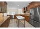 Spacious kitchen with stainless steel appliances, granite countertops, and center island at 962 Marco Ne Dr, St Petersburg, FL 33702